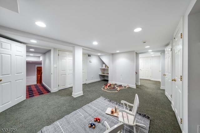 basement featuring dark colored carpet