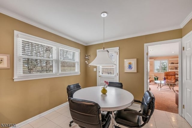 dining space with crown molding, light tile patterned floors, and baseboards