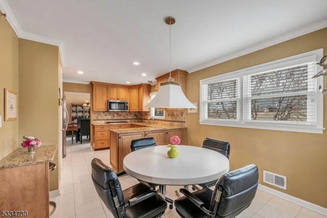 dining space with crown molding, light tile patterned flooring, baseboards, and visible vents