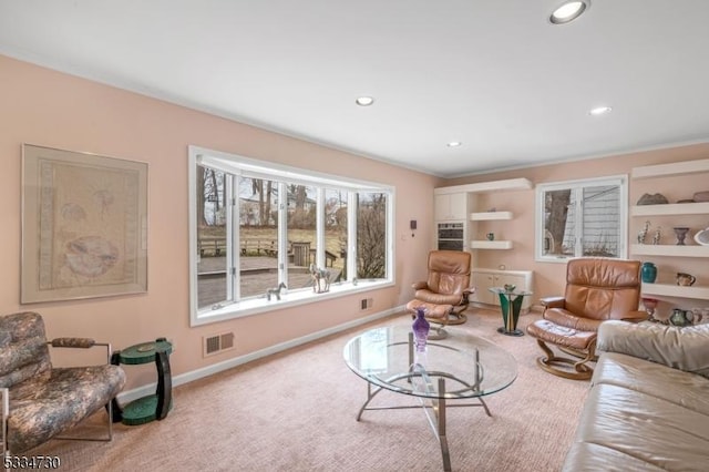 carpeted living area with visible vents, recessed lighting, and baseboards