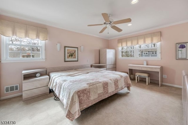 bedroom featuring light carpet, visible vents, multiple windows, and baseboards