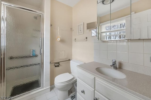 bathroom featuring vanity, decorative backsplash, a shower stall, tile patterned floors, and toilet