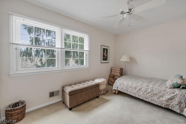 carpeted bedroom featuring visible vents, baseboards, and ceiling fan