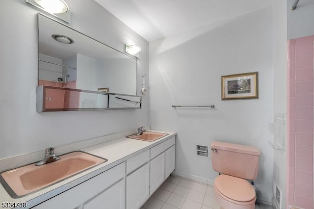 full bath with tile patterned flooring, double vanity, toilet, and a sink