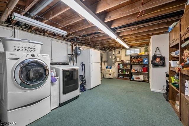 laundry room featuring laundry area, electric panel, and separate washer and dryer