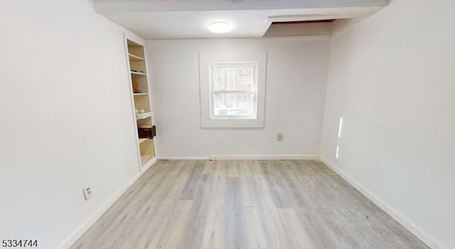 empty room with light hardwood / wood-style flooring