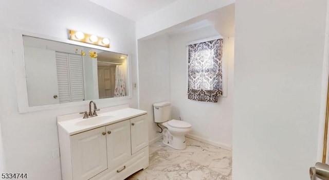 bathroom featuring vanity and toilet