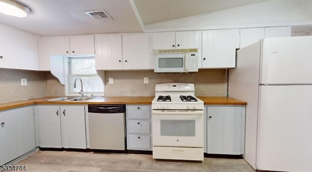 kitchen with sink, white cabinets, and white appliances