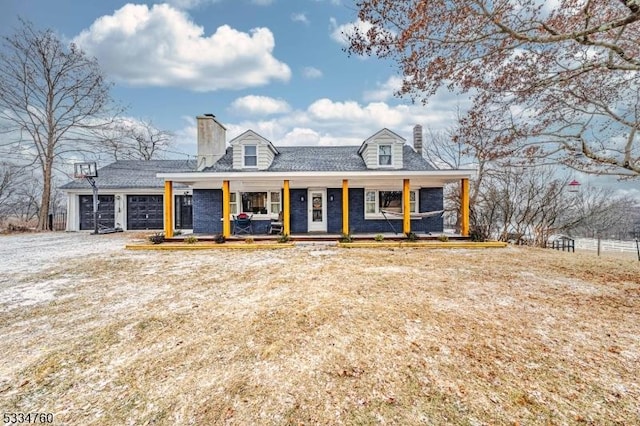 cape cod home featuring a garage and a porch