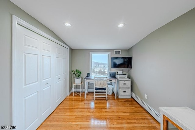 office with light wood-type flooring and baseboard heating