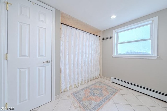 bathroom with tile patterned flooring, a baseboard radiator, and curtained shower