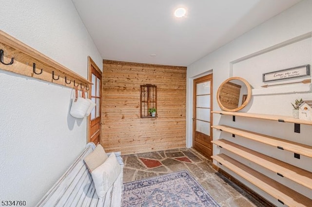 mudroom with wooden walls