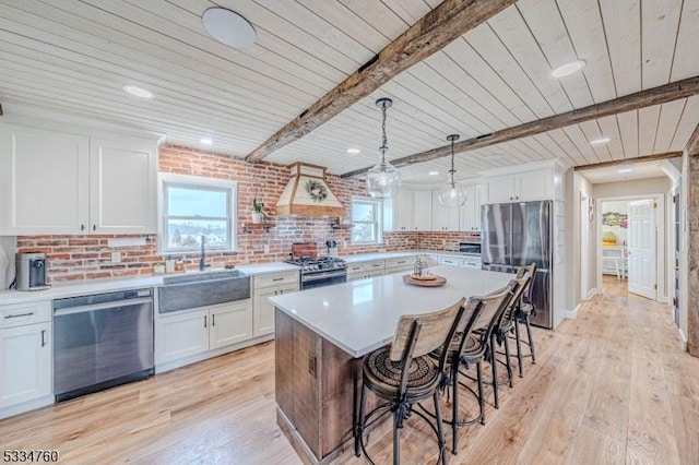 kitchen featuring white cabinetry, appliances with stainless steel finishes, and light wood-type flooring