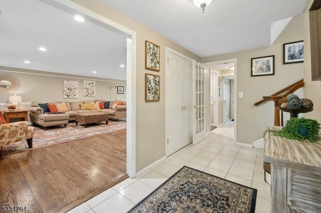 foyer with light tile patterned flooring, baseboards, and recessed lighting