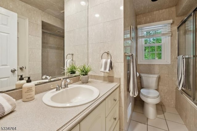 bathroom featuring tile walls, tile patterned floors, vanity, and toilet