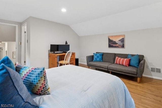 bedroom with baseboards, wood finished floors, lofted ceiling, and recessed lighting