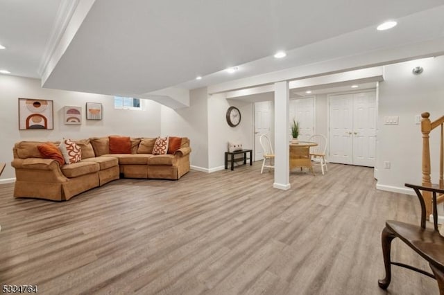 living room with recessed lighting, light wood-style flooring, and baseboards