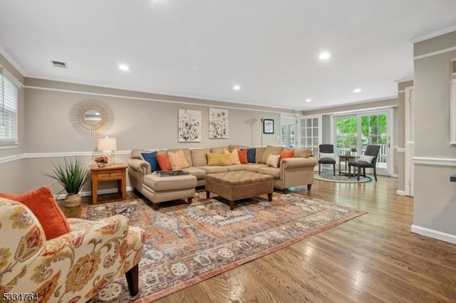 living room with ornamental molding, wood finished floors, baseboards, and recessed lighting
