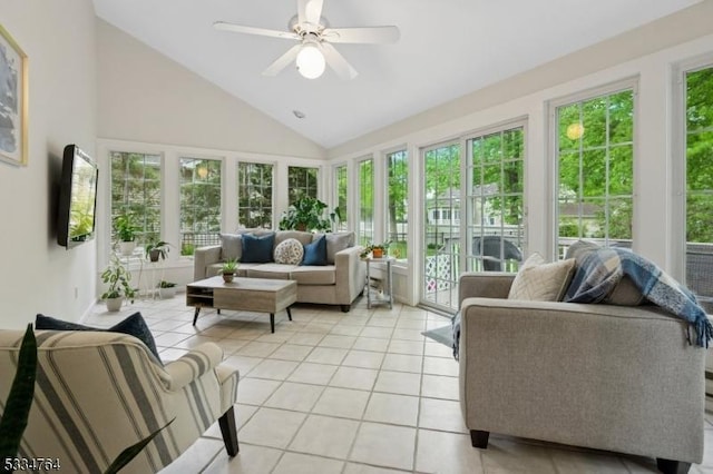 sunroom / solarium with tile patterned flooring and high vaulted ceiling