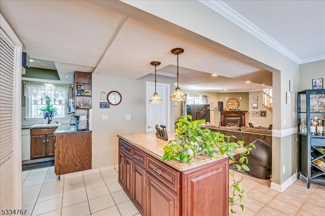 kitchen with dishwasher, hanging light fixtures, a kitchen island, ornamental molding, and light tile patterned flooring