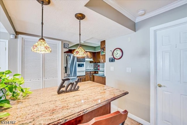 kitchen featuring light tile patterned floors, stainless steel fridge, white double oven, decorative backsplash, and decorative light fixtures