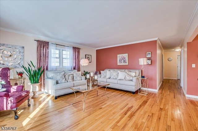 living room featuring crown molding and light hardwood / wood-style flooring