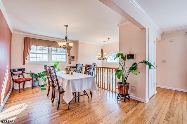 dining room featuring crown molding, a notable chandelier, and light wood-type flooring