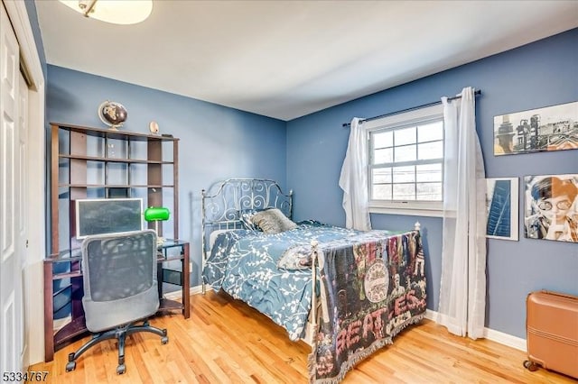 bedroom featuring hardwood / wood-style floors and a closet