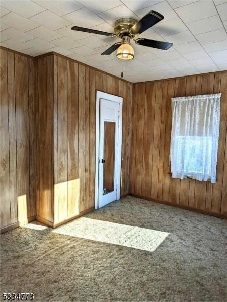 empty room featuring ceiling fan and light colored carpet