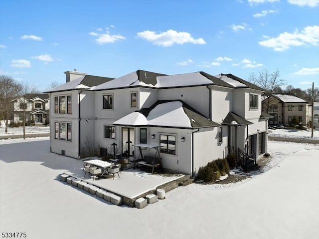 snow covered property featuring a garage