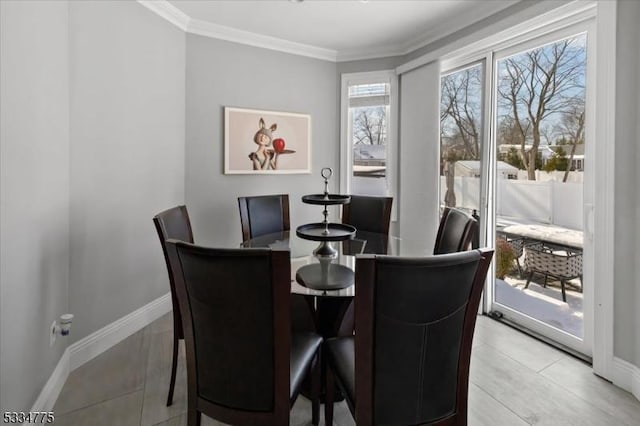 dining room featuring light tile patterned floors and ornamental molding