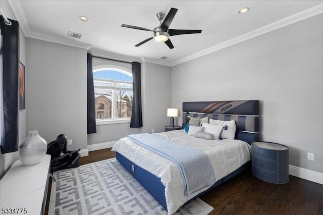 bedroom featuring dark hardwood / wood-style flooring, ornamental molding, and ceiling fan