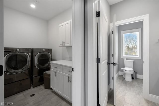 laundry area featuring cabinets and washer and dryer