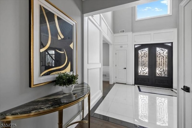 entryway with french doors and a high ceiling