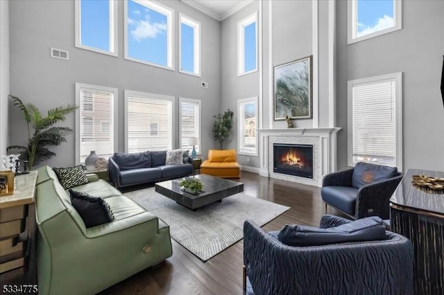 living room with ornamental molding and dark hardwood / wood-style flooring