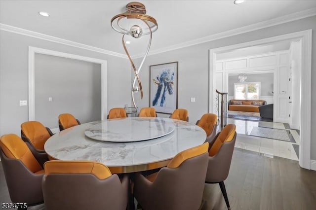 dining area with crown molding and wood-type flooring