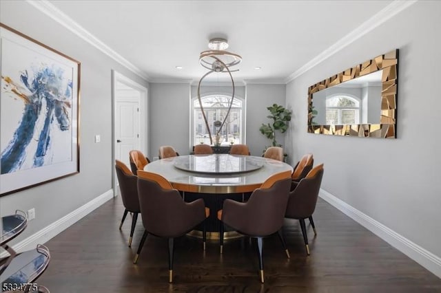 dining space with ornamental molding and dark hardwood / wood-style floors