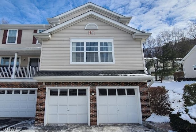 view of snow covered exterior featuring a garage