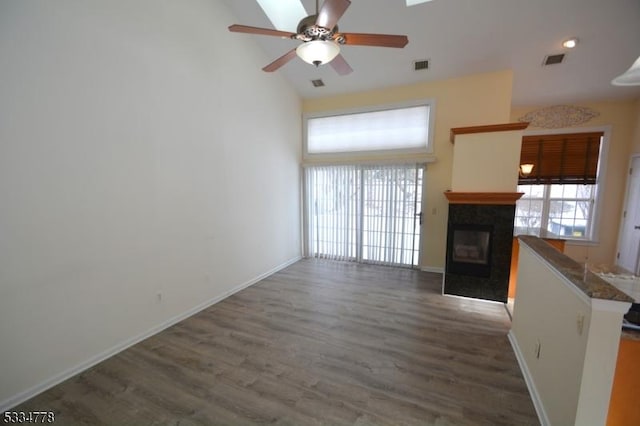 unfurnished living room with high vaulted ceiling, dark hardwood / wood-style floors, and ceiling fan