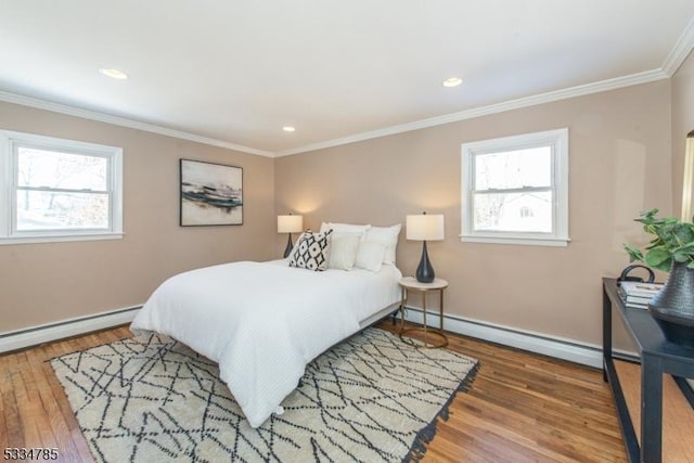 bedroom featuring crown molding, wood-type flooring, and baseboard heating