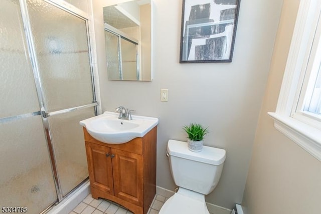 bathroom with vanity, toilet, and a shower with door