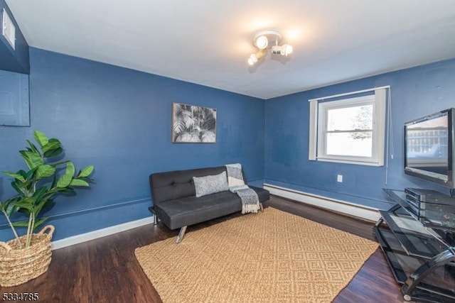 sitting room featuring dark hardwood / wood-style floors and a baseboard heating unit