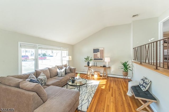 living room with vaulted ceiling, a baseboard radiator, and wood-type flooring