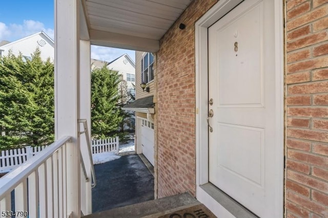 doorway to property featuring brick siding