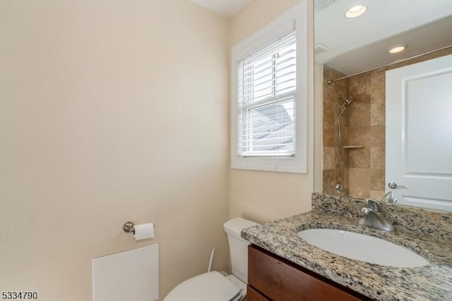 full bathroom featuring recessed lighting, vanity, toilet, and walk in shower