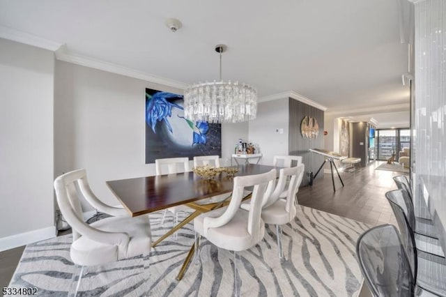 dining area featuring dark wood-type flooring, ornamental molding, and a notable chandelier