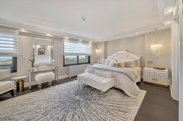 bedroom with dark hardwood / wood-style floors and a notable chandelier