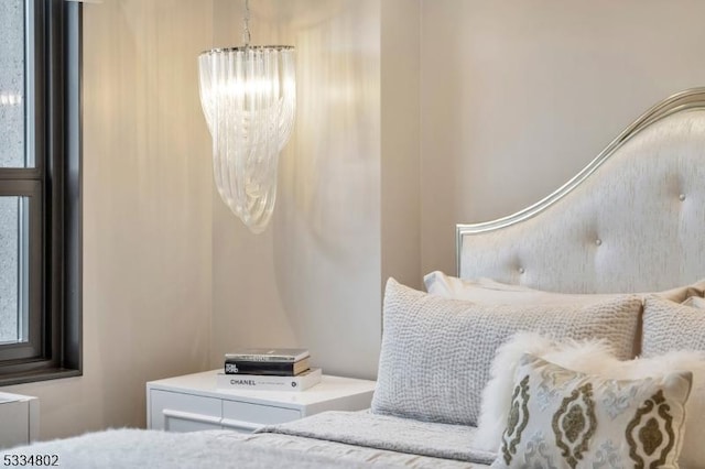 bedroom featuring a notable chandelier