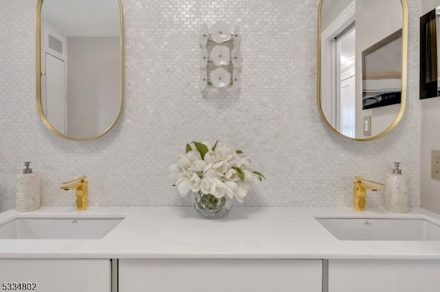 bathroom featuring vanity and tasteful backsplash