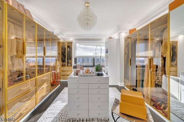 spacious closet with dark hardwood / wood-style floors and a chandelier